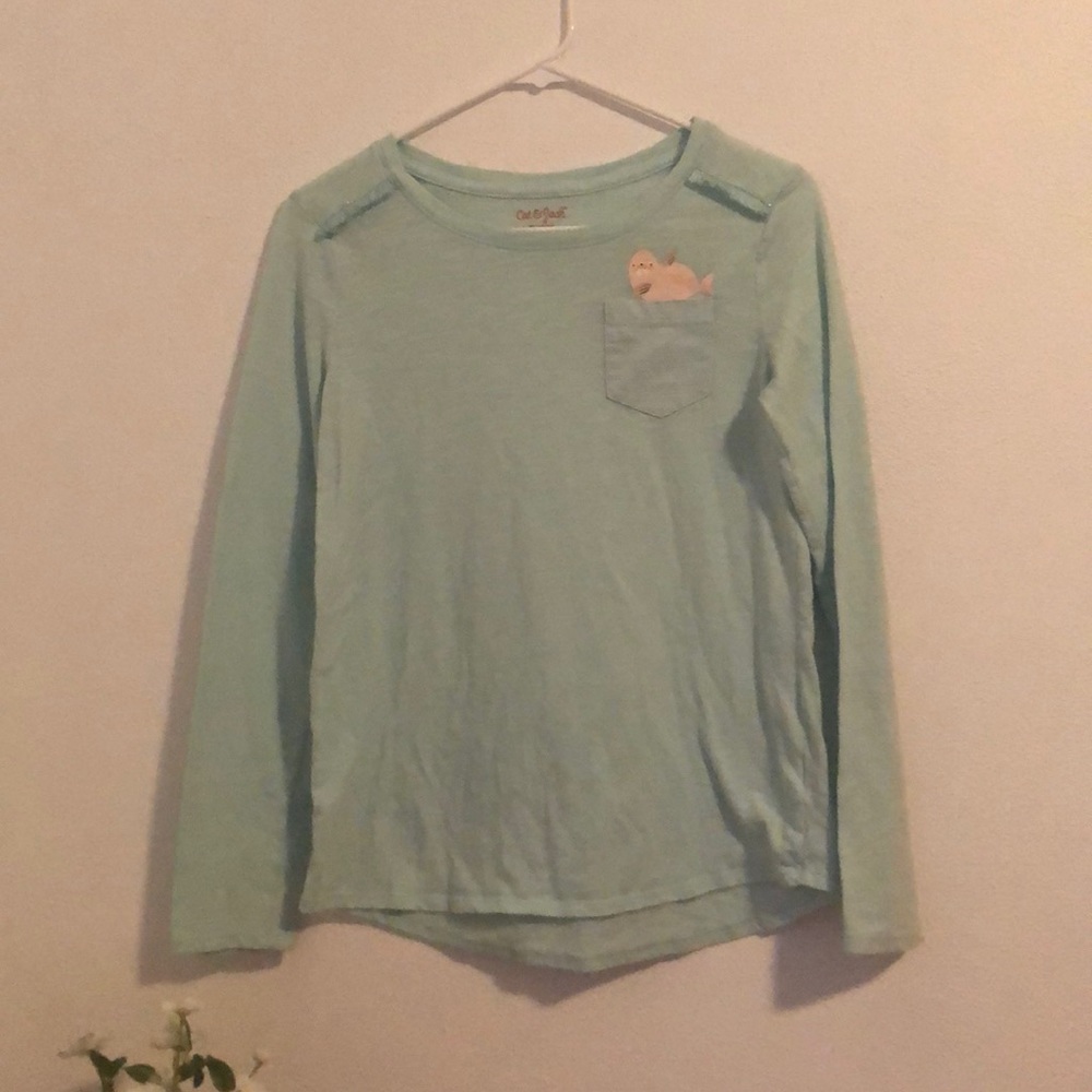 A long sleeve shirt that has cool designs on the front.